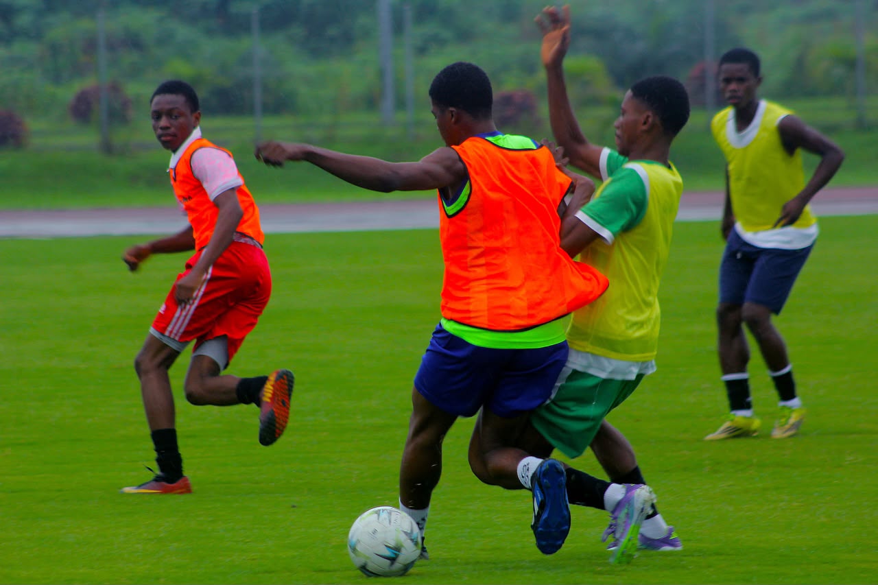 Camp Gee Football Academy players competing for the ball in a small-sided training game