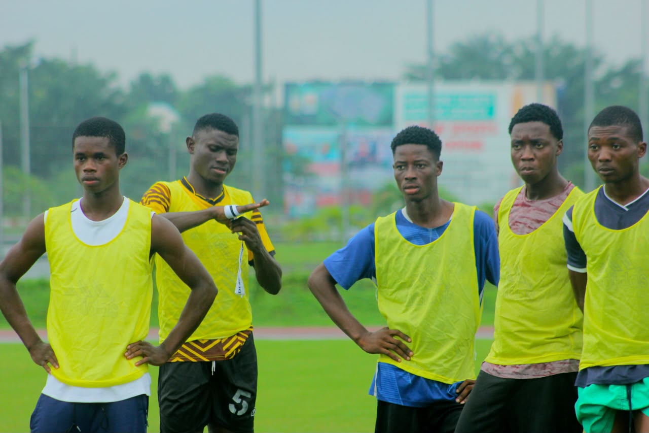 Trialists in training bibs waiting for the next drill at a Camp Gee Football Academy trial in Uyo
