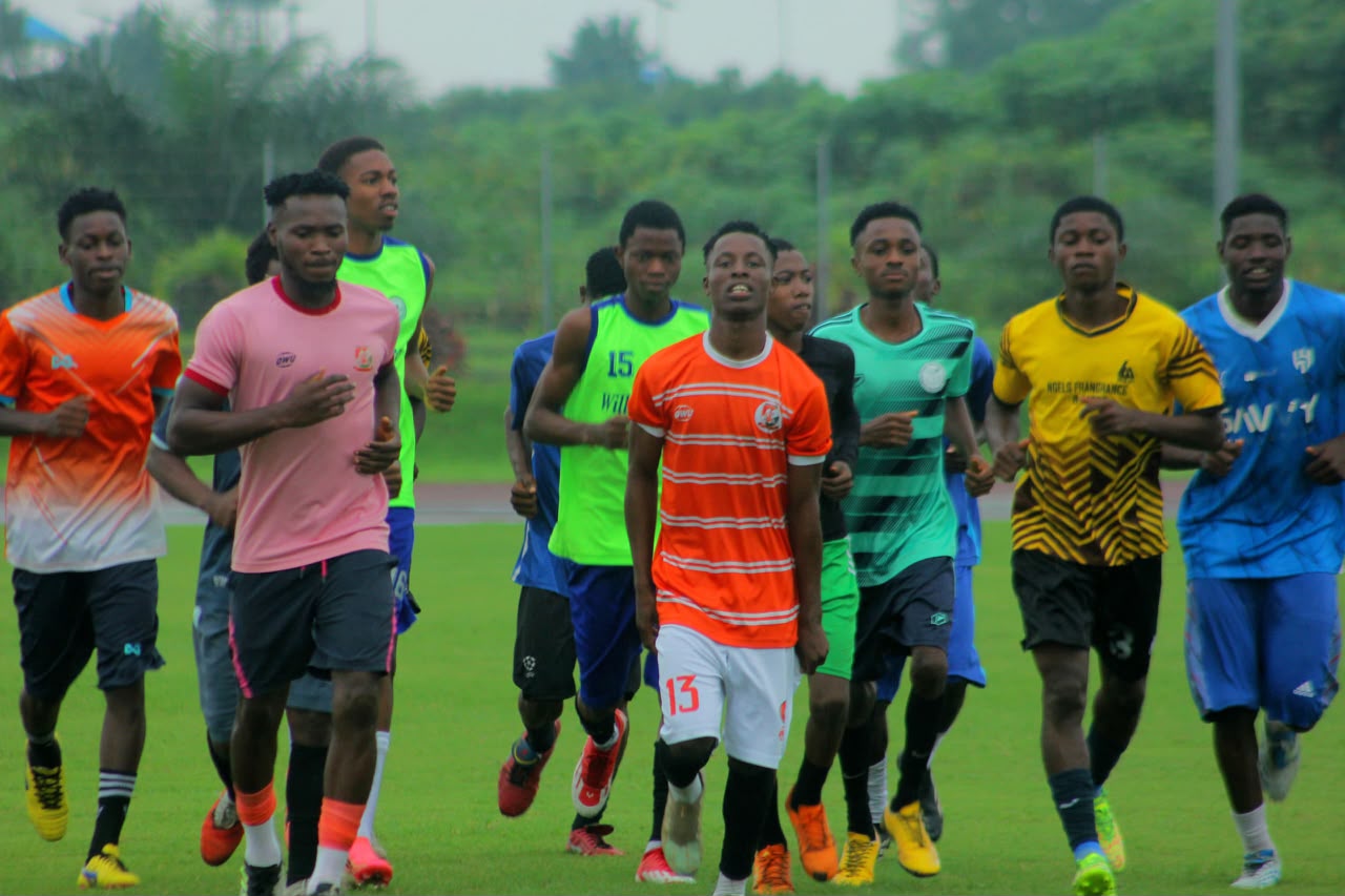 Camp Gee Football Academy squad completing a group warm-up run on the training pitch