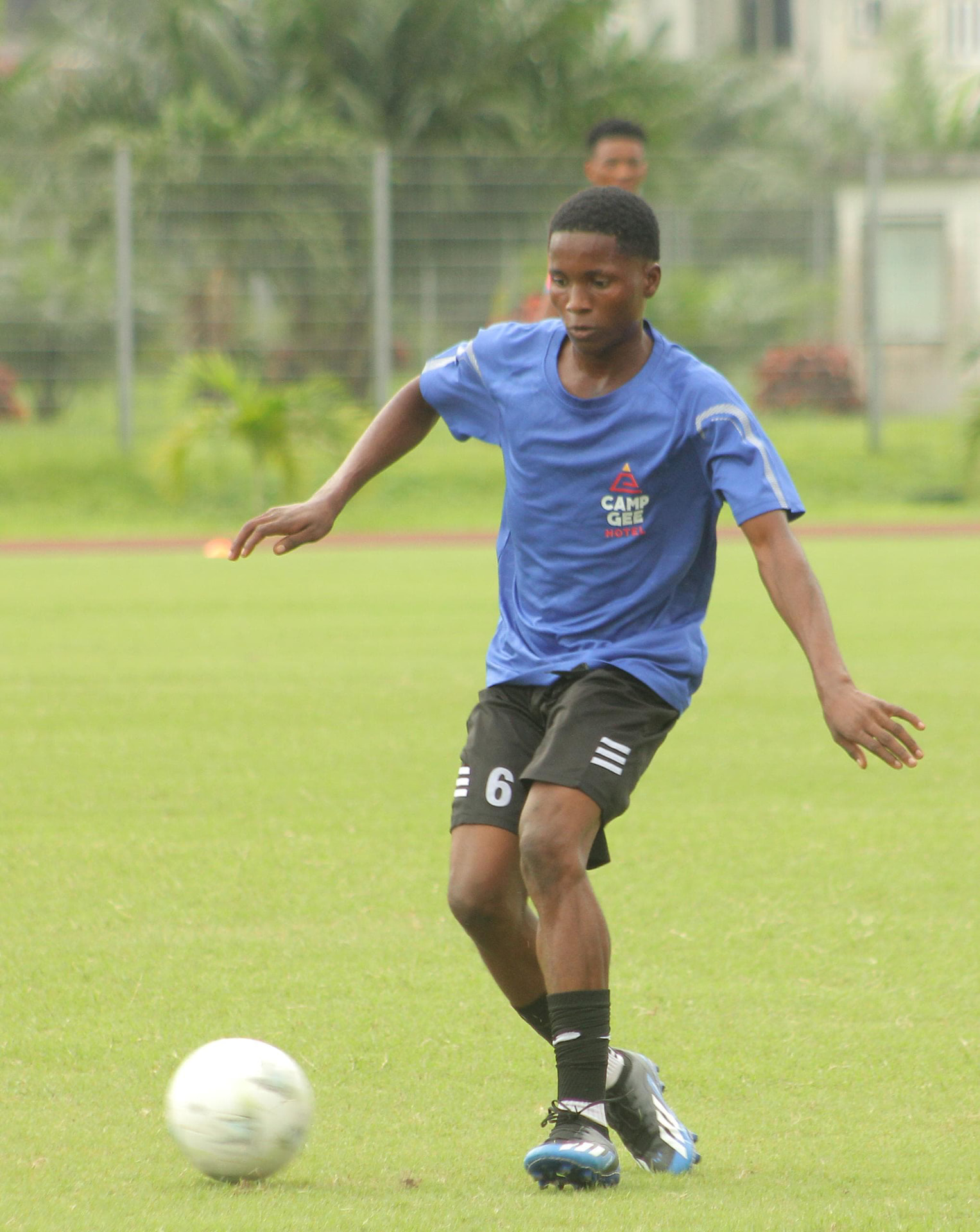 Camp Gee Football Academy player driving forward with the ball during training in Uyo